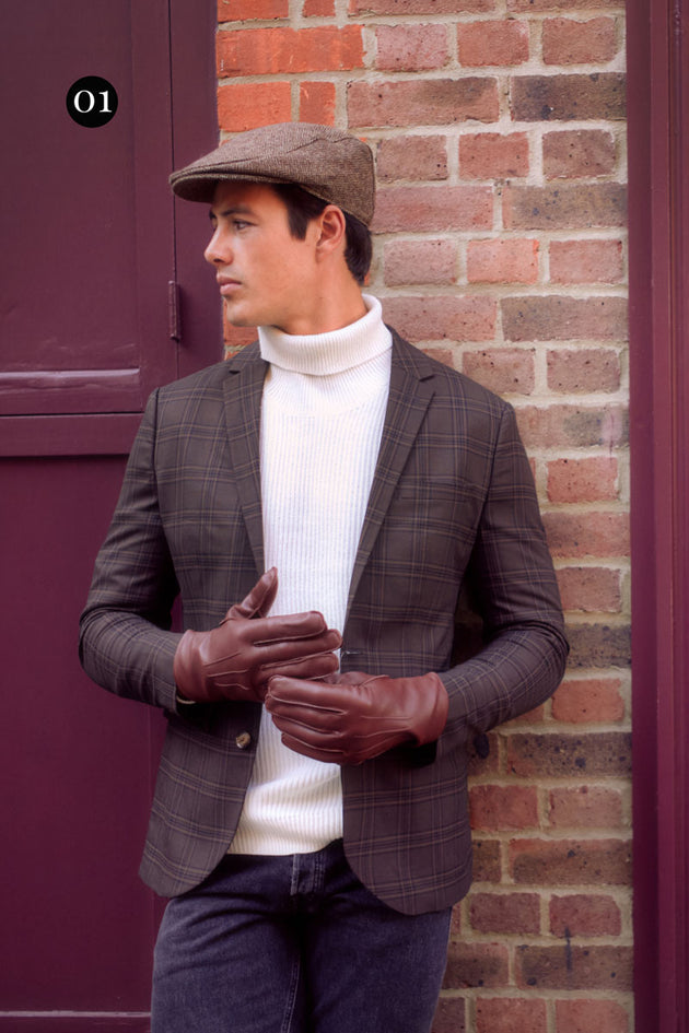 man wearing brown leather gloves and a chocolate Abraham Moon flat cap 