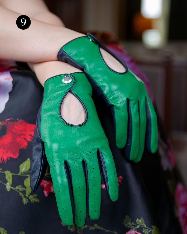 Close up of woman wearing touchscreen leather driving gloves in green/navy with dress indoors. 